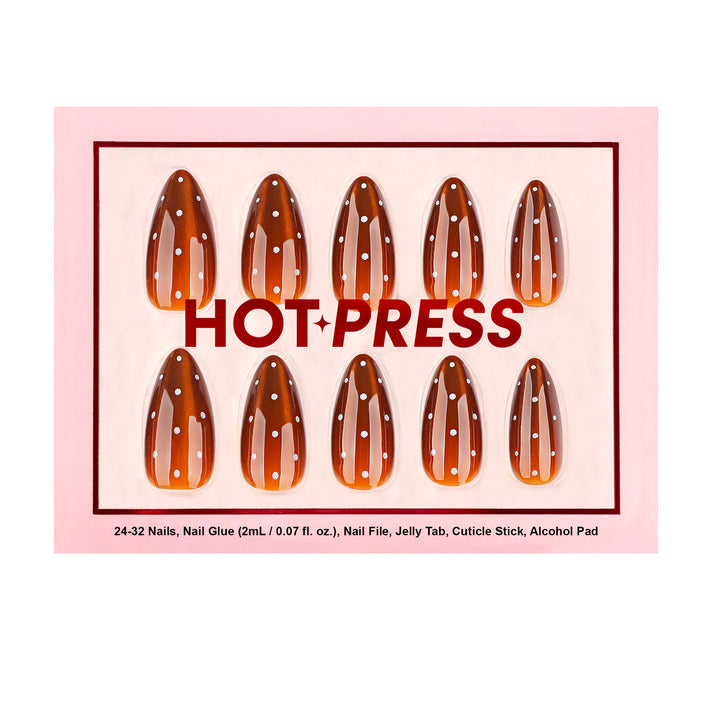 Almond-shaped press-on nails featuring a shimmering brown cat-eye magnetic effect and a vertical row of white polka dots.