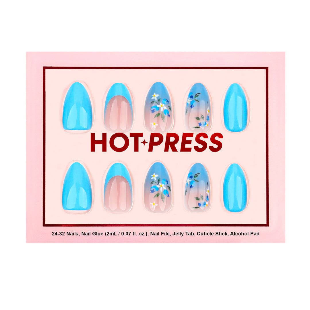 Medium almond press-on nails featuring a bright blue ombré effect, solid blue nails, and sheer-base nails with detailed blue and white floral illustrations.