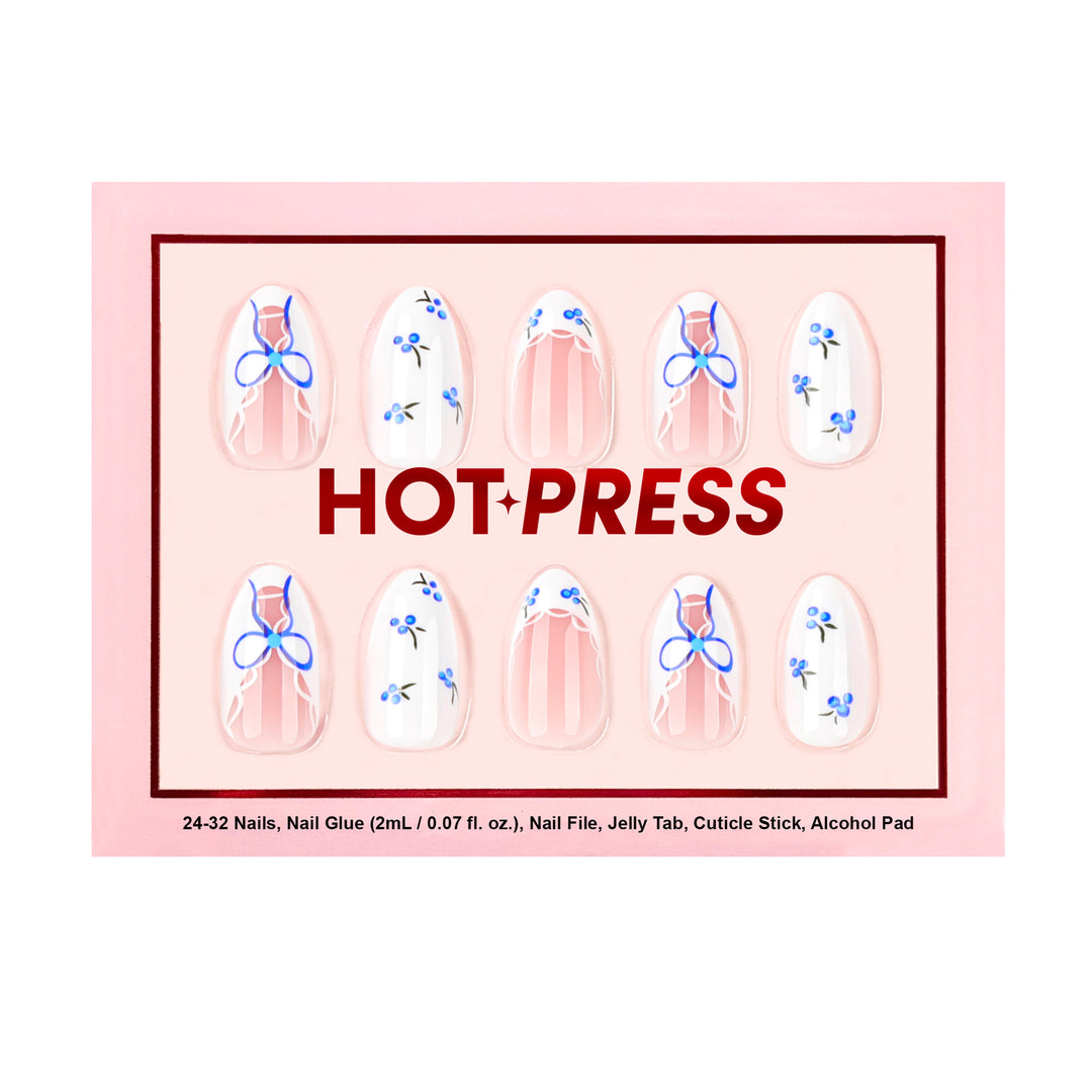 Medium almond press-on nails with a sheer base, featuring vibrant cobalt blue bows, white lace-style French tips, and delicate blueberry illustrations.
