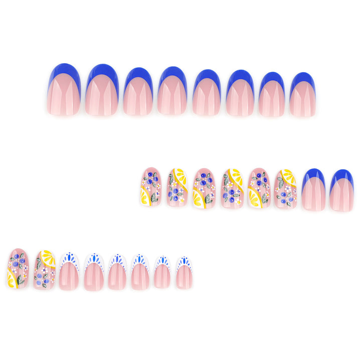 Medium oval press-on nails featuring cobalt blue French tips and detailed lemon slices with blueberry and floral art on a sheer base.