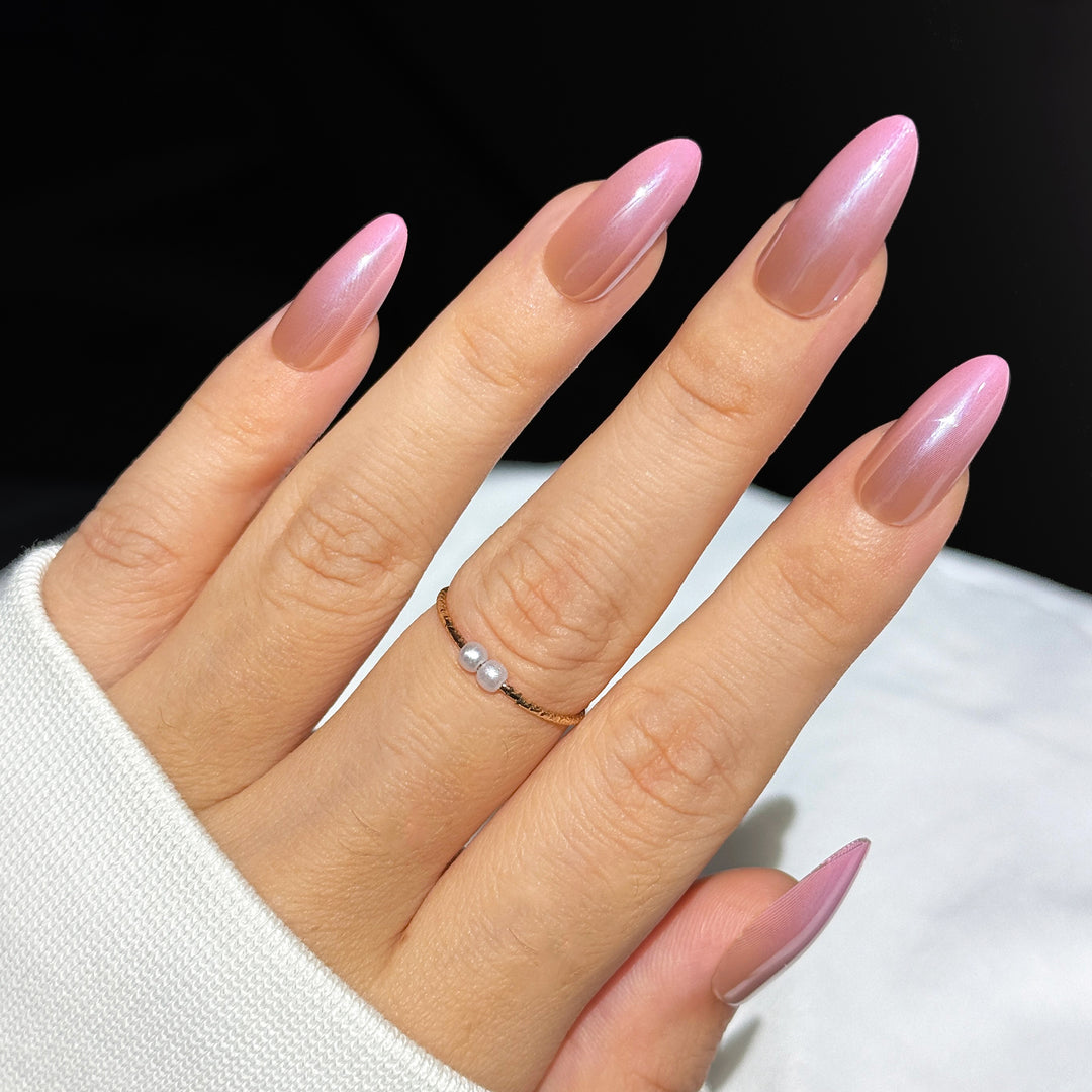 Boujee Blush short almond press-on nails featuring a rich dark nude base transitioning into a vibrant pink gradient ombre fade.