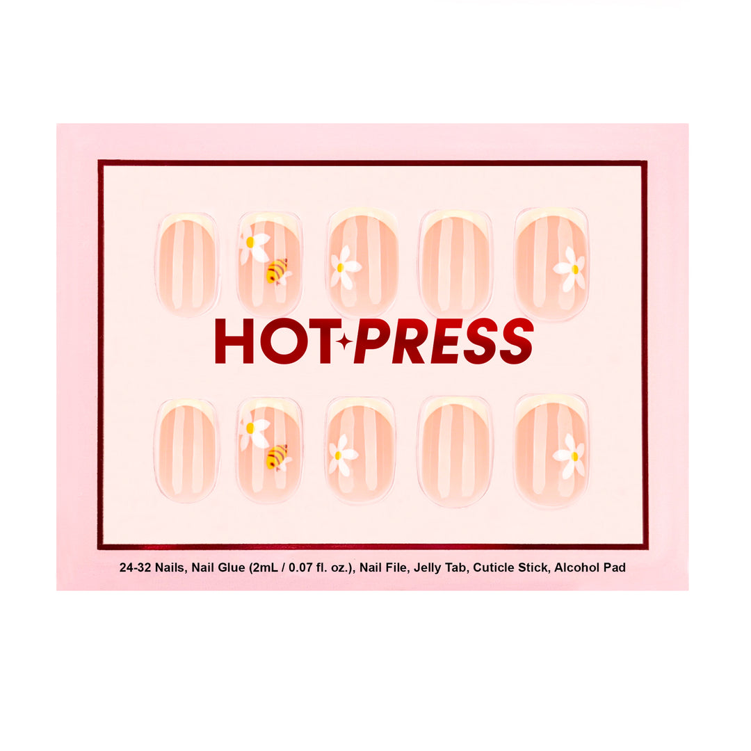 Short square press-on nails with a sheer nude base, featuring white vertical stripes, delicate white daisies, and a yellow and black honeybee illustration.