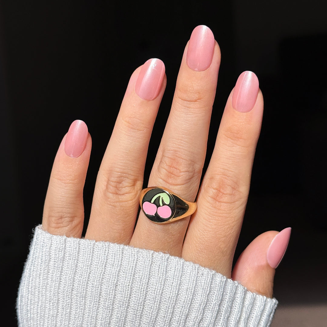Chloé Cream medium almond press-on nails featuring a soft baby pink base detailed with a highly reflective pearlescent glazed donut chrome overlay finish.