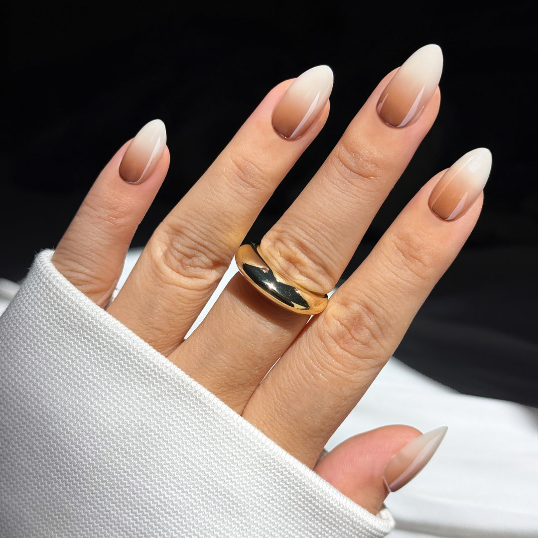 Creme de Coco almond press-on nails featuring a seamless dark nude to white gradient ombre design.