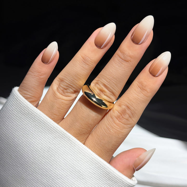 Creme de Coco almond press-on nails featuring a seamless dark nude to white gradient ombre design.