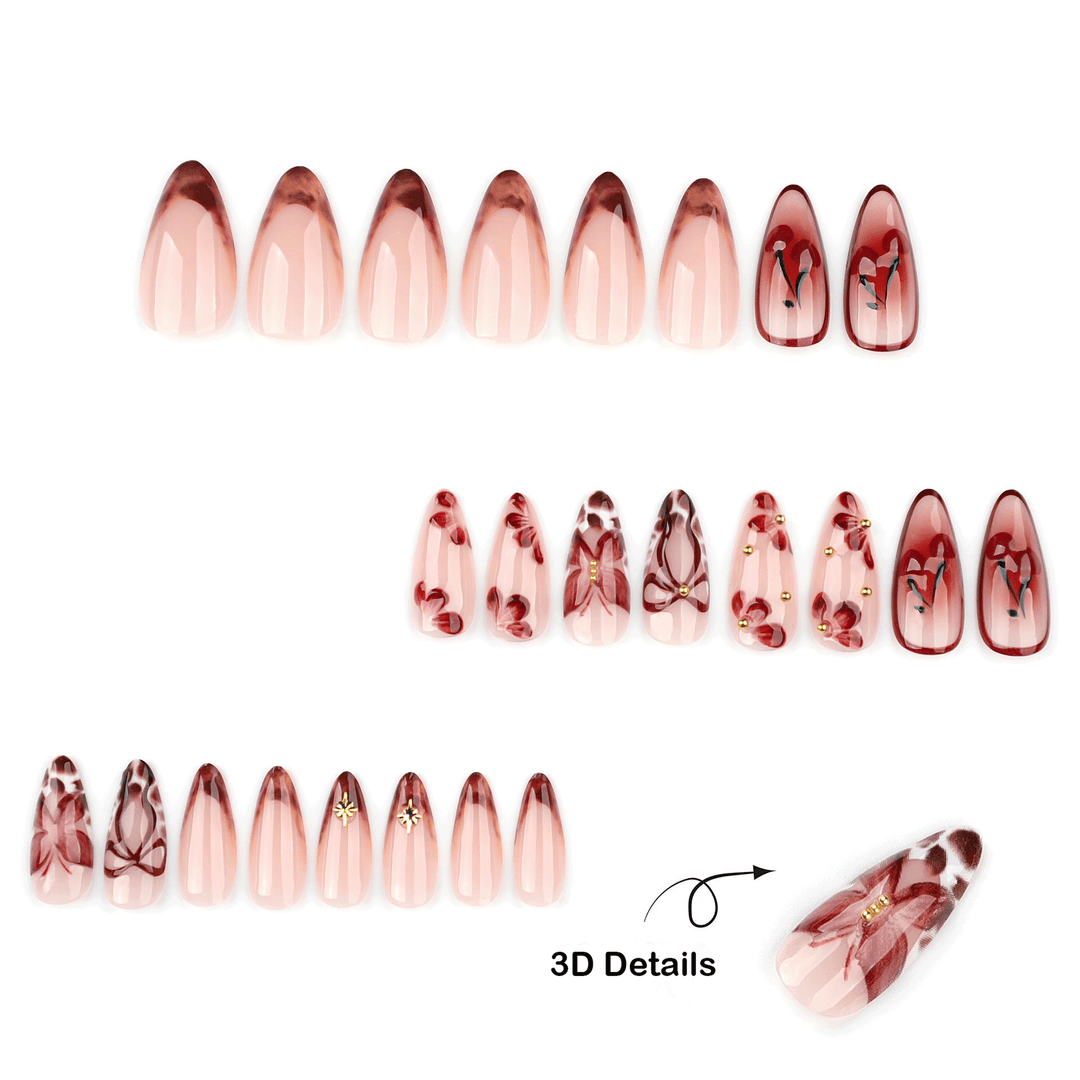 set of press on nails featuring brown marble French tips, cherries, burgundy bows, and floral accents. This design reads as coquette meets luxe, with a slightly vintage, café-chic aesthetic.