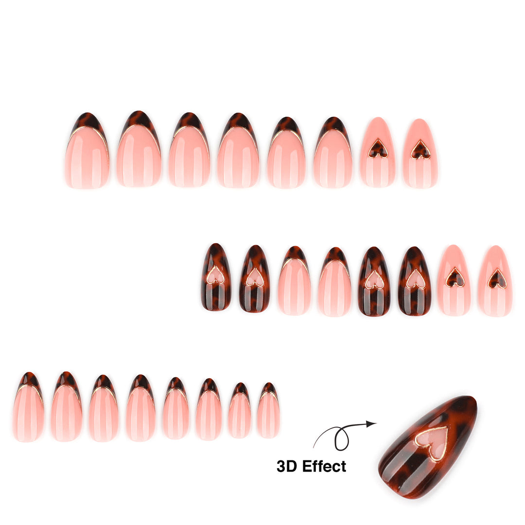 Tapered almond press-on nails featuring a mix of tortoiseshell patterns and peach-nude bases. Some nails have tortoiseshell French tips with gold metallic edges, while others feature 3D gold-rimmed heart charms. The finish is smooth and highly glossy.