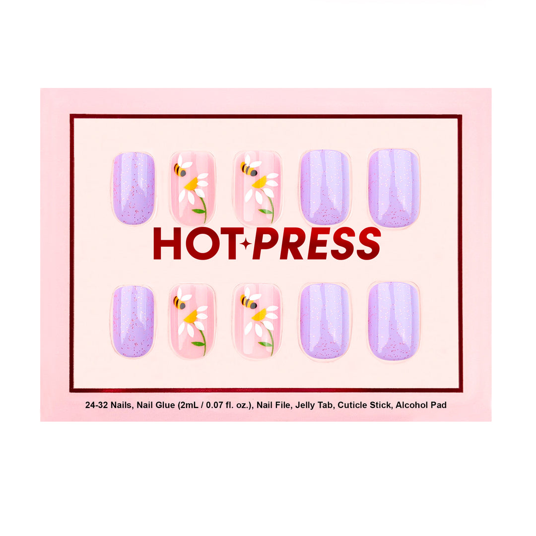 Short square press-on nails featuring a mix of shimmering purple glazed nails and sheer-base nails with white daisies and yellow honeybee illustrations.