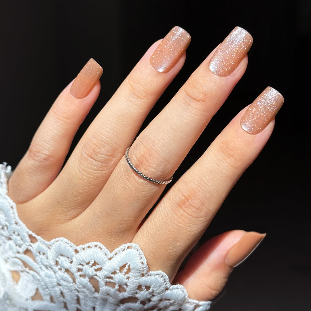 Mimosa short square press-on nails featuring a luxurious champagne gold base detailed with a highly reflective velvet cat-eye magnetic shimmer flash.