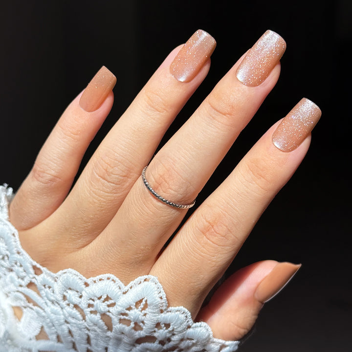 Mimosa short square press-on nails featuring a luxurious champagne gold base detailed with a highly reflective velvet cat-eye magnetic shimmer flash.