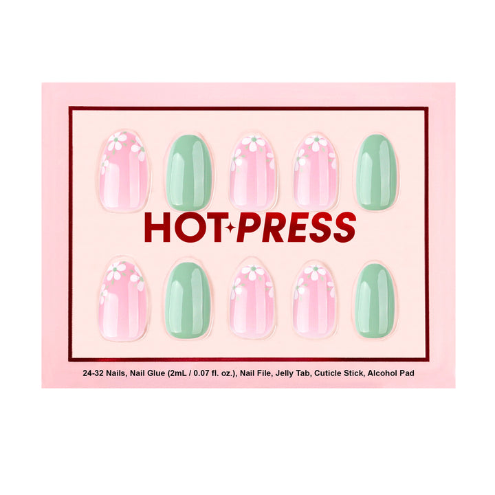 Short oval press-on nails featuring a mix of solid sage green nails and sheer pink nails decorated with white daisy floral patterns.