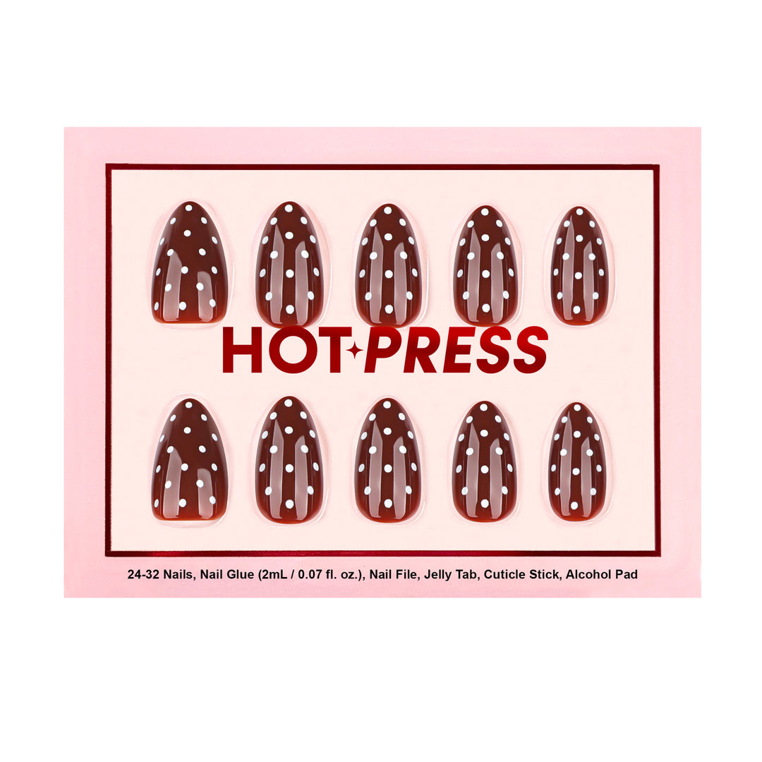 Almond-shaped press-on nails with a glossy deep maroon base and a white polka dot pattern.