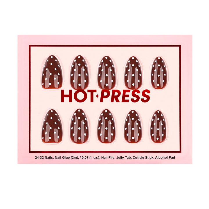 Almond-shaped press-on nails with a glossy deep maroon base and a white polka dot pattern.