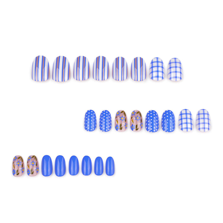 Short round press-on nails featuring a mix of periwinkle blue art including gingham plaid, vertical stripes, polka dots, and delicate sheer-base blue floral designs and bumble bee.