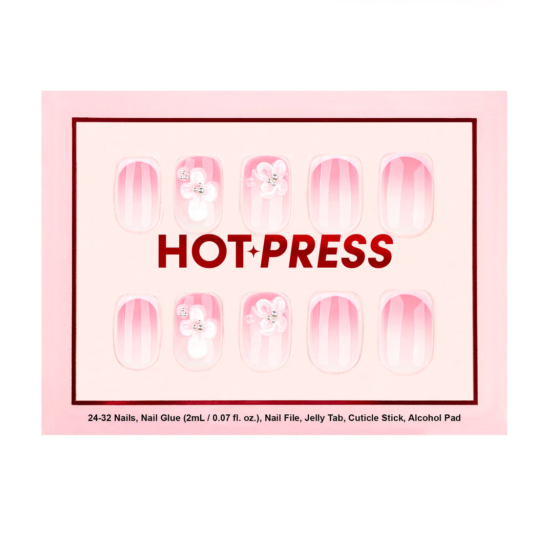Short square press-on nails with a soft pink aura gradient and hand-sculpted 3D white floral accents finished with silver gemstone centers.