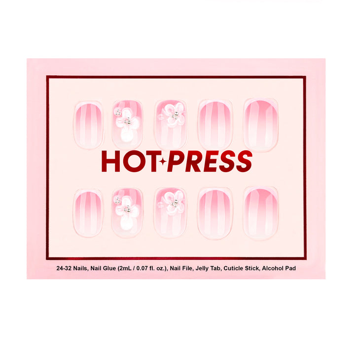 Short square press-on nails with a soft pink aura gradient and hand-sculpted 3D white floral accents finished with silver gemstone centers.