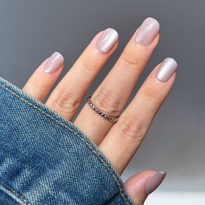 ink Guava short square press-on nails featuring a soft baby pink base topped with a brilliant multi-dimensional velvet cat-eye magnetic shimmer.