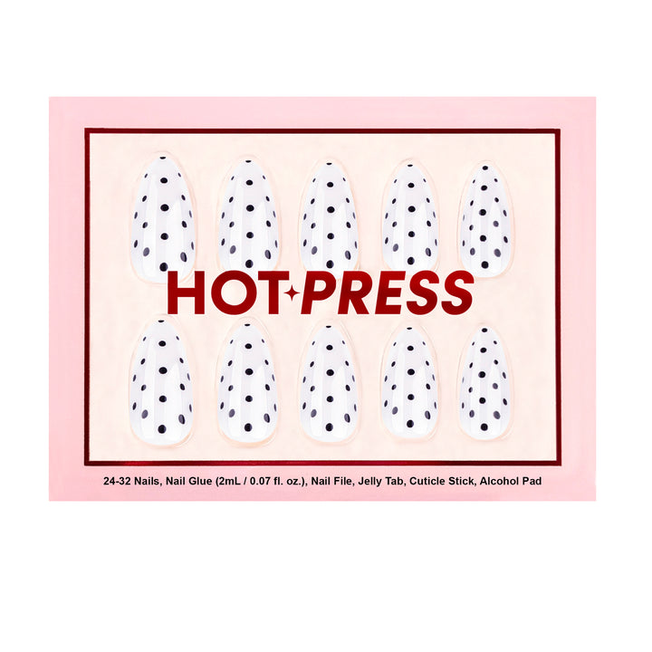 Short almond-shaped press-on nails featuring a glossy white base color and a structured black polka dot pattern resembling poppy seeds.