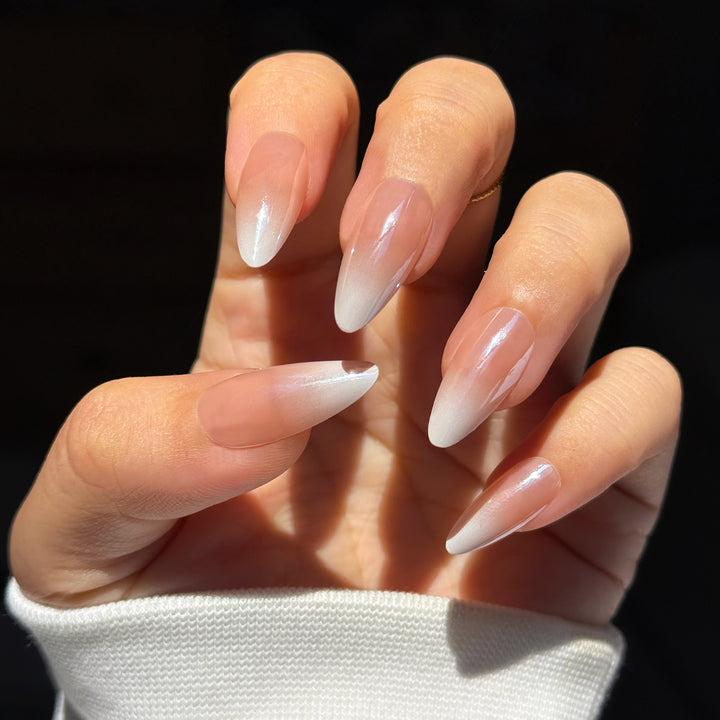Powder Sugar Ombre Almond press-on nails featuring a soft, flawless pink and white gradient fade design.