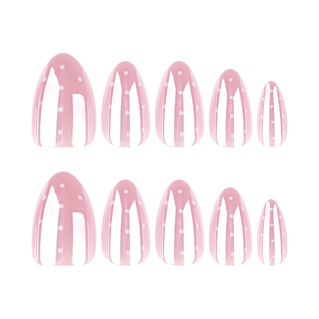 Almond shaped press-on nails featuring a soft baby pink base color and white polka dot accents.