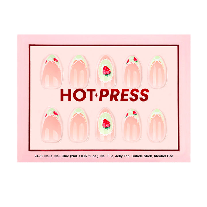 Light pink press-on nails with light green French tips, white lace patterns, and small red strawberry nail art. The middle nail features a single strawberry inside a white lace frame.