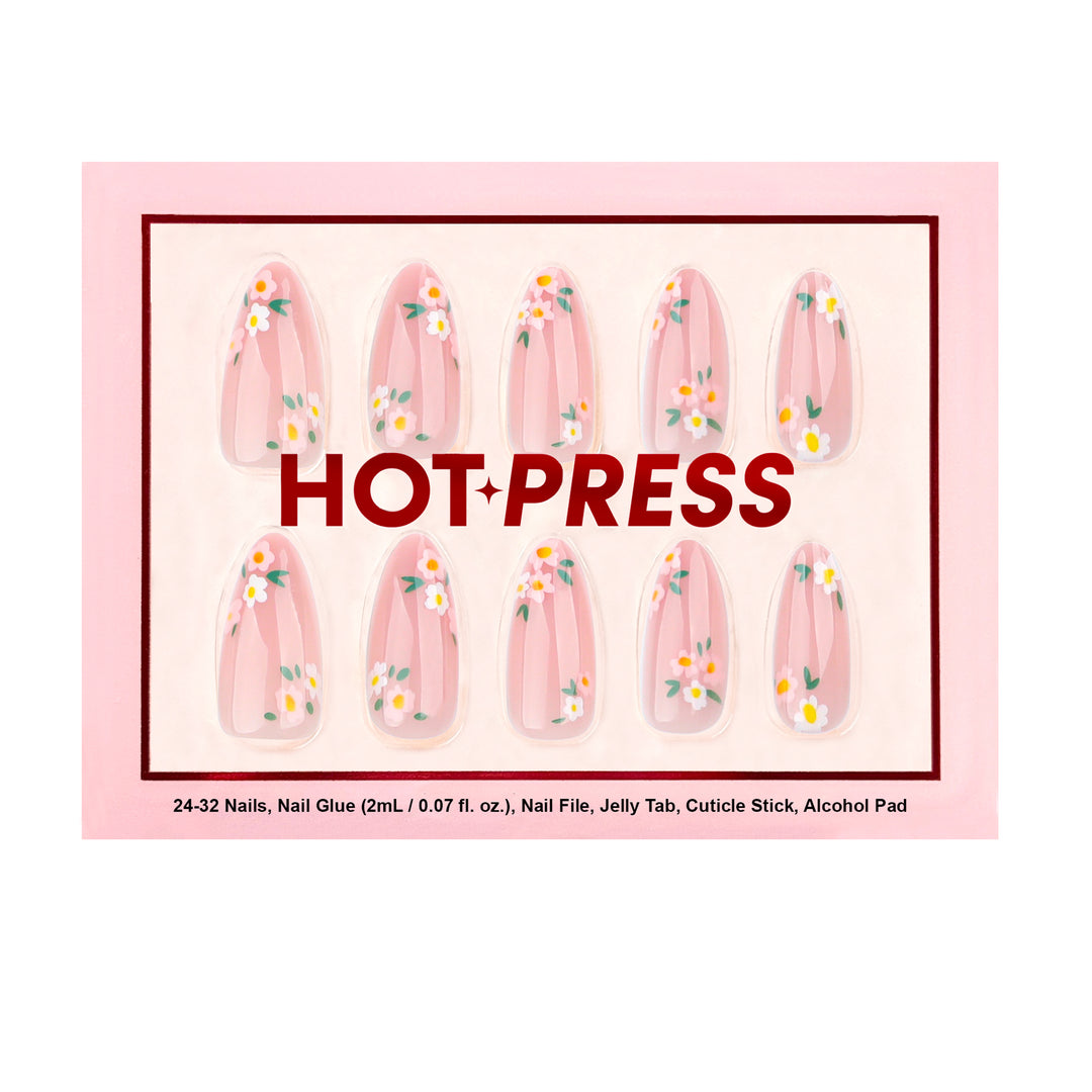 Medium almond press-on nails with a sheer pink jelly base, featuring dainty white and pink wildflower art with green leaf accents.