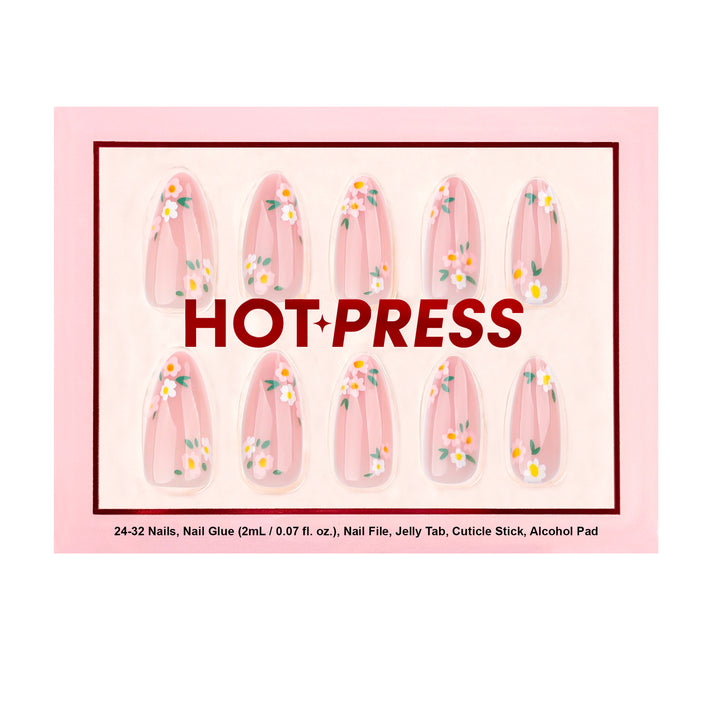 Medium almond press-on nails with a sheer pink jelly base, featuring dainty white and pink wildflower art with green leaf accents.