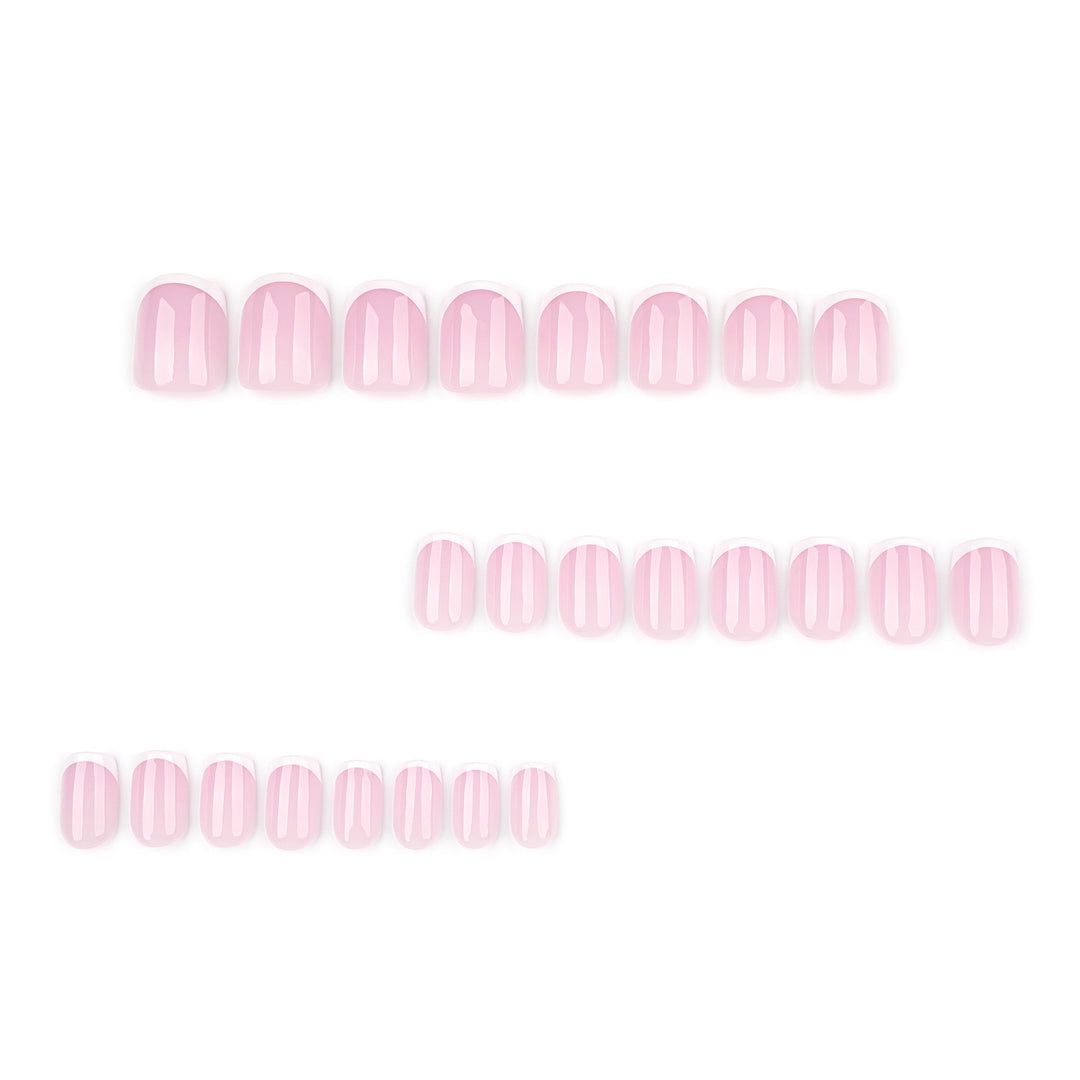 French Cupid short almond press-on nails featuring a high-gloss milky nude base with white French tips and a pattern of mini pink hearts.
