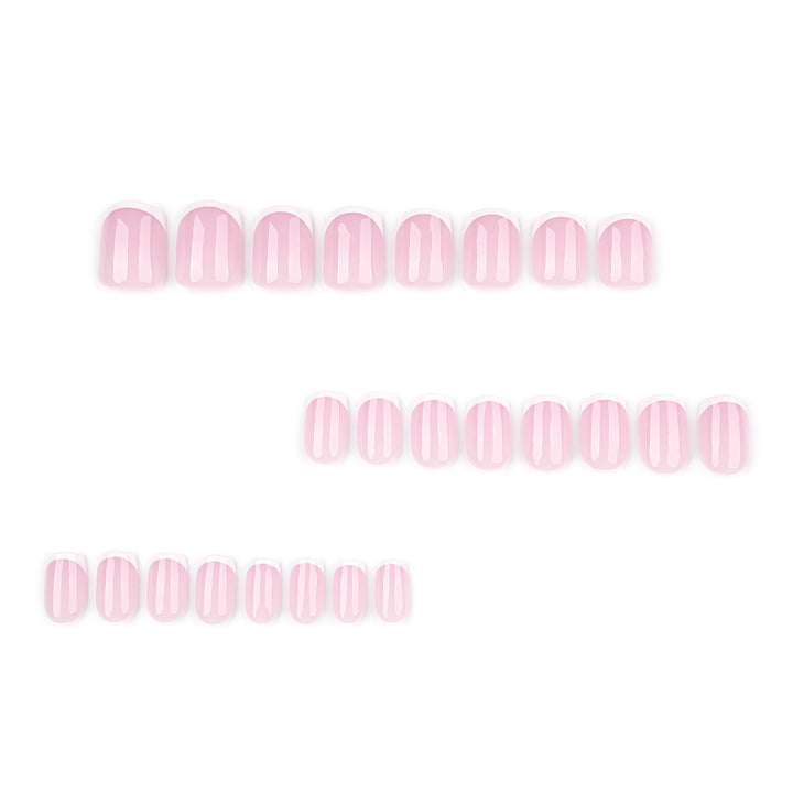 French Cupid short almond press-on nails featuring a high-gloss milky nude base with white French tips and a pattern of mini pink hearts.