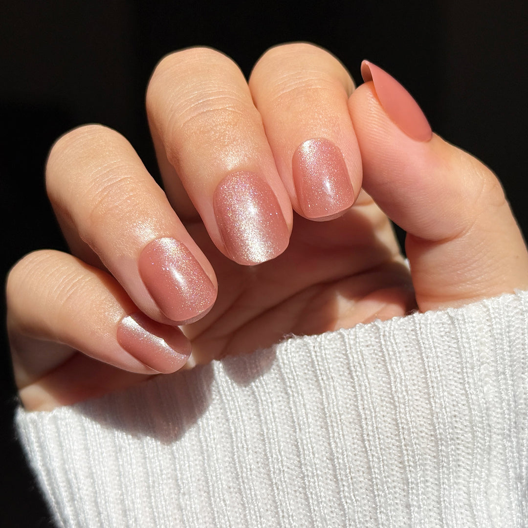 Peach Magnet short square press-on nails featuring a warm peach base topped with a highly reflective rose gold and champagne velvet cat-eye magnetic flash shimmer.