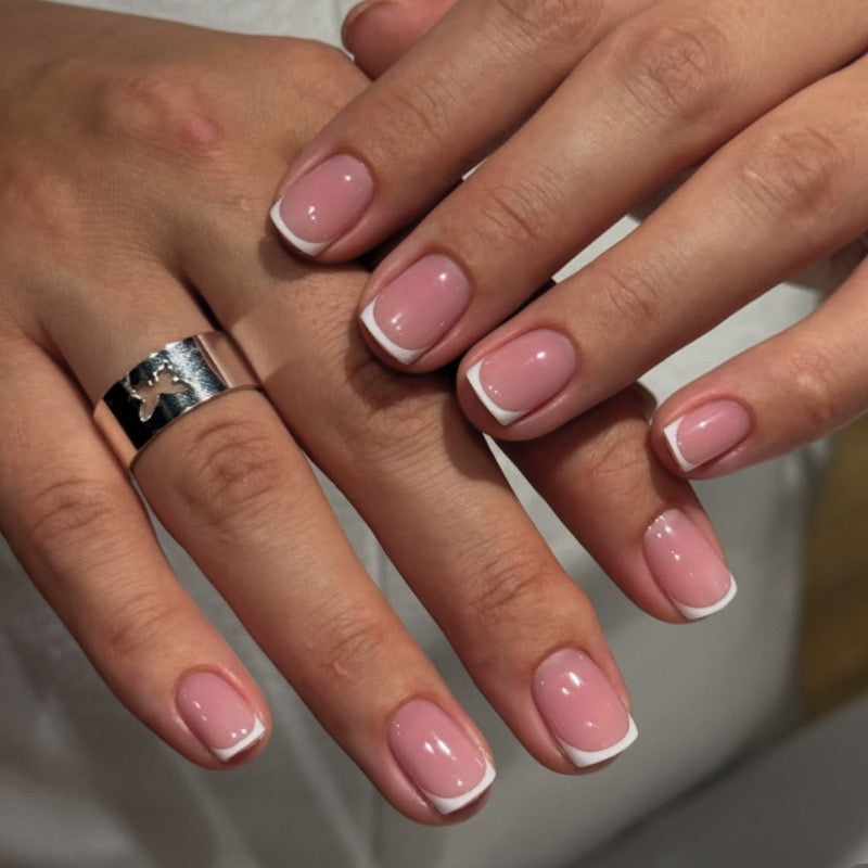 Pixie Edge French short square press-on nails featuring a high-gloss translucent pink base with white French tips.