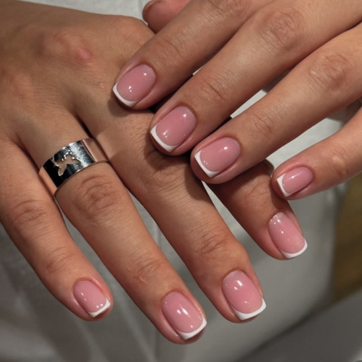 Pixie Edge French short square press-on nails featuring a high-gloss translucent pink base with white French tips.