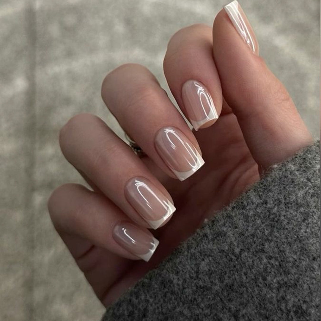 Vanilla Glaze French short square press-on nails featuring a luminous iridescent pearlescent pink base with white French tips and a glazed donut chrome finish.